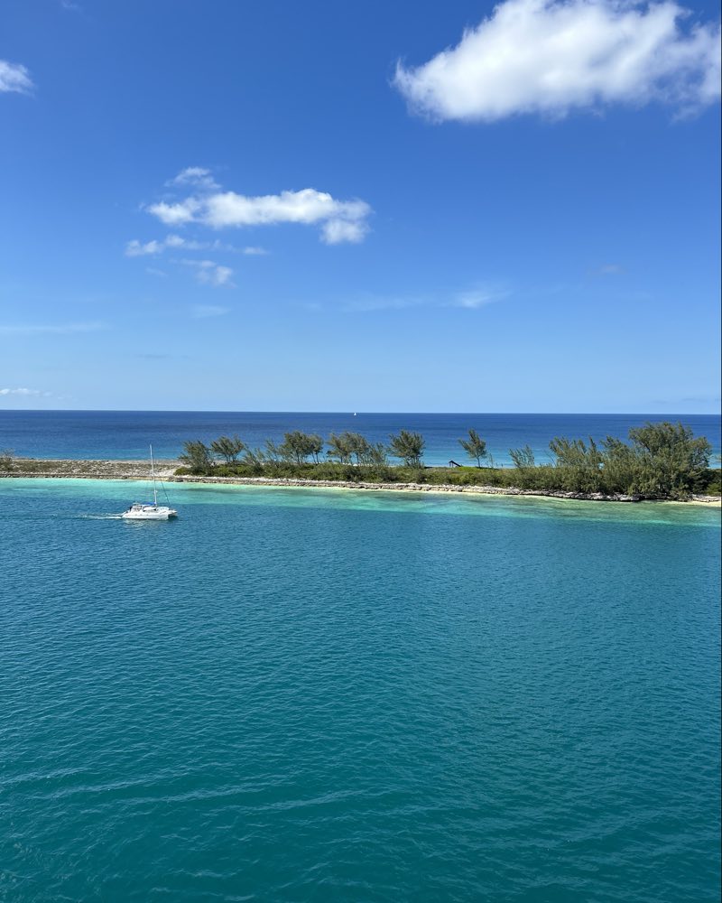 Turquoise water and a small island seen from a cruise ship